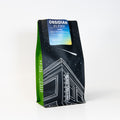 Coffee bag labeled 'Obsidian Blend' with a starry night design on a white background