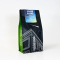 Coffee bag labeled 'House Blend' with a black and green design on a white background