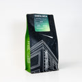 Coffee bag from Costa Rica with green and black design on a white background